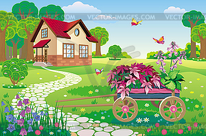 Beautiful garden with house and garden wheelbarrow