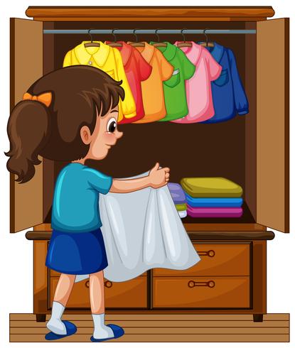 Girl putting away clothes in closet