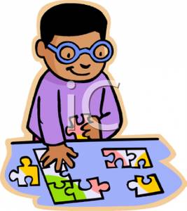 Boy With Glasses Putting Together a Jigsaw Puzzle