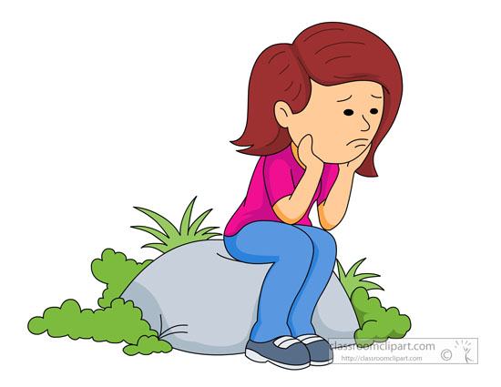 Girl sitting on rock with sad face