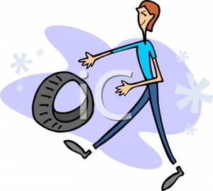 A Man Rolling a Tire Down the Street