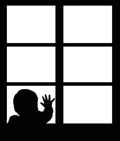 Silhouette of little baby waving hand on the window